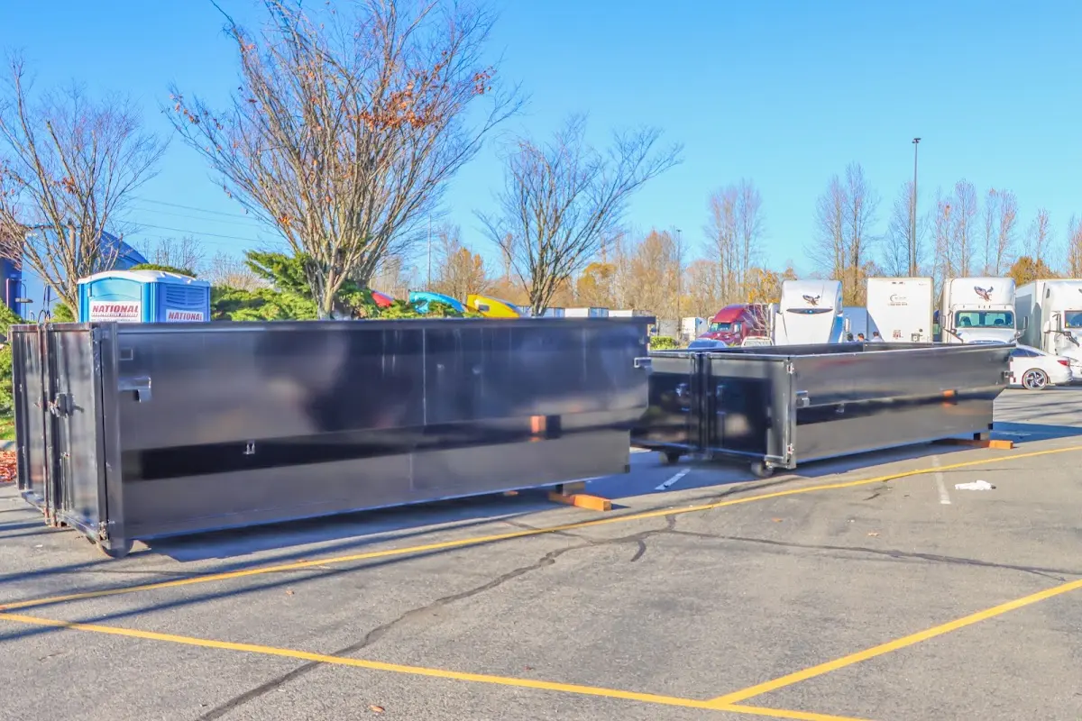 Professional dumpster rental service with roll-off container on residential driveway in Burtonsville